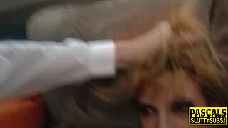 Busty whore kneels down, throats cock hard, and gags uncontrollably.
