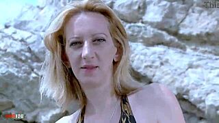 A mature woman in a bikini performs a striptease